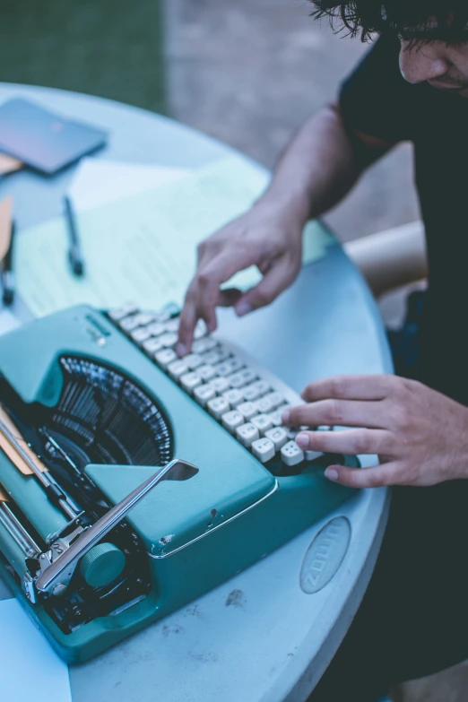 a person that is using an old fashioned typewriter