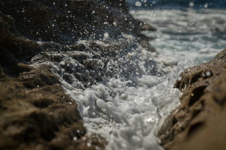 water splashes over large rocks as they move along them