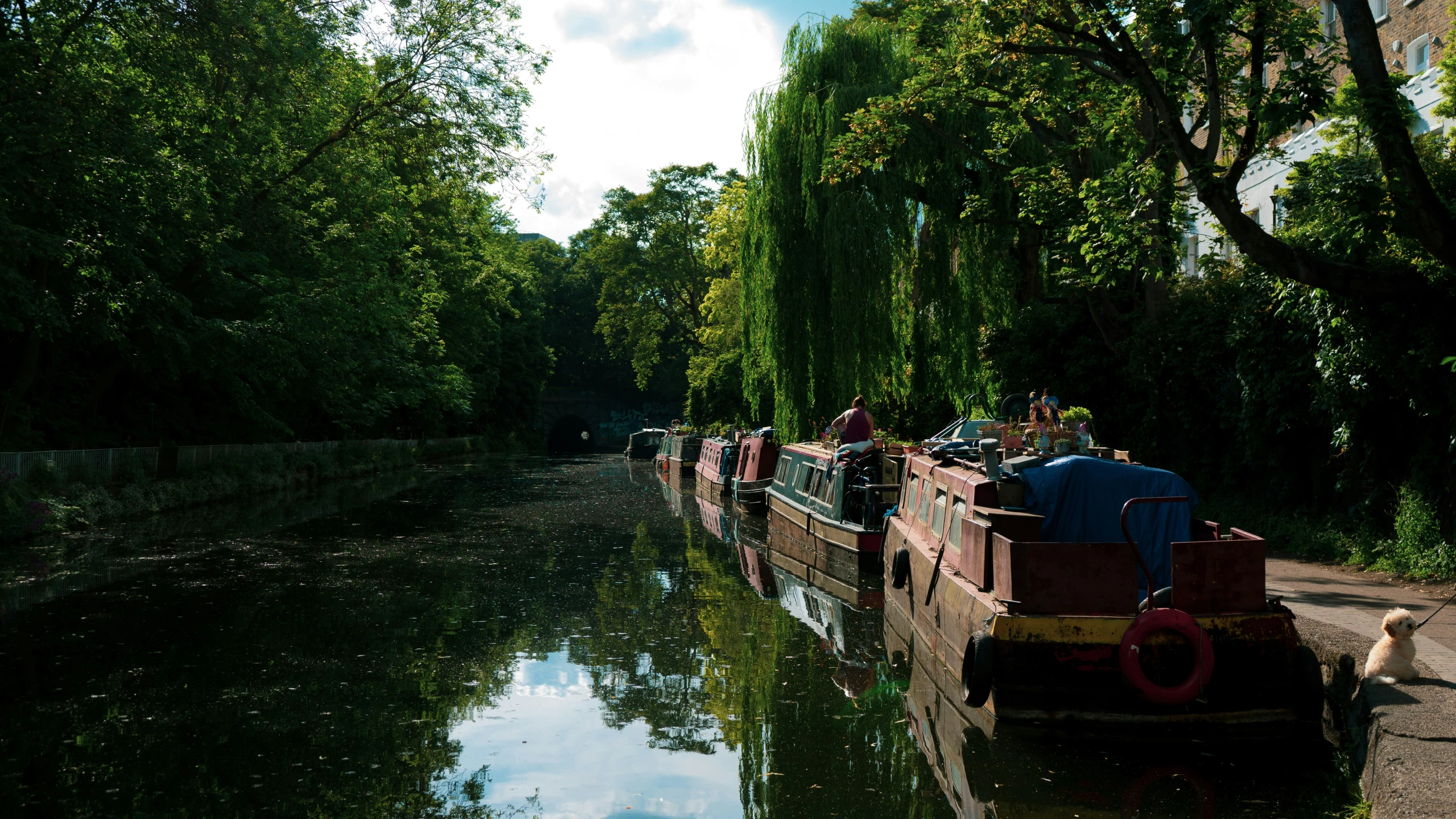 people are standing on the side of a small boat