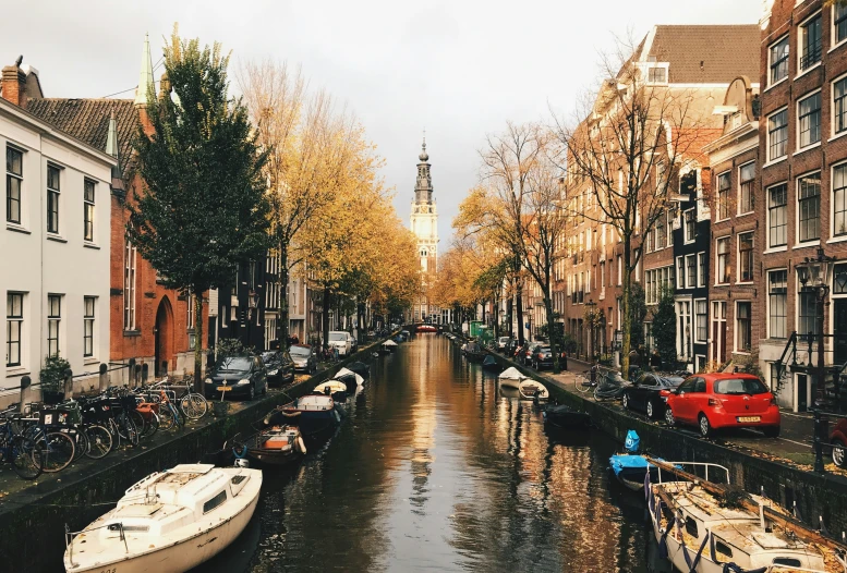 many boats are parked along a canal in the city