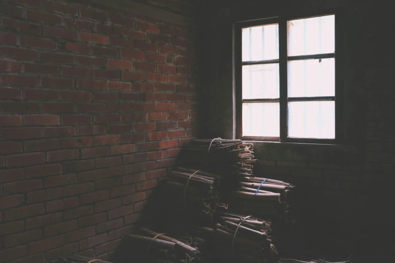 many stacks of papers are in front of a window