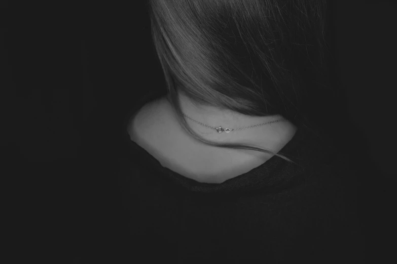 black and white pograph of the back side of a woman's neck