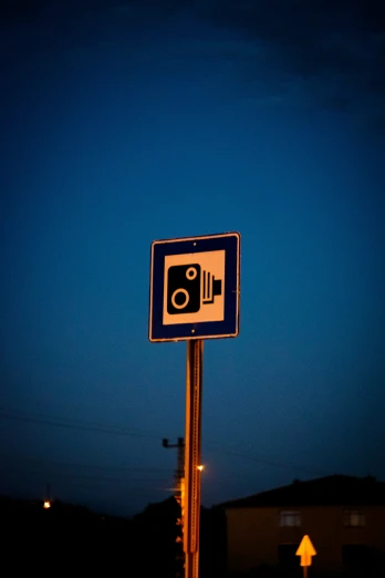 a blue street sign sitting next to a light pole