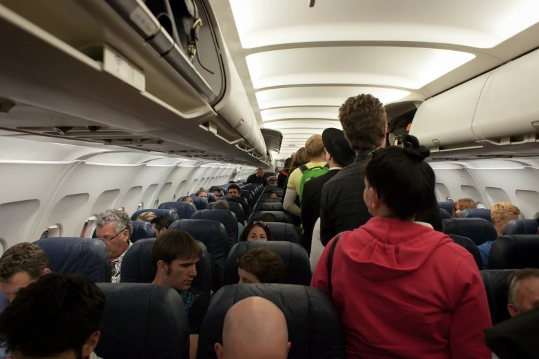 people sitting and walking around in an airplane