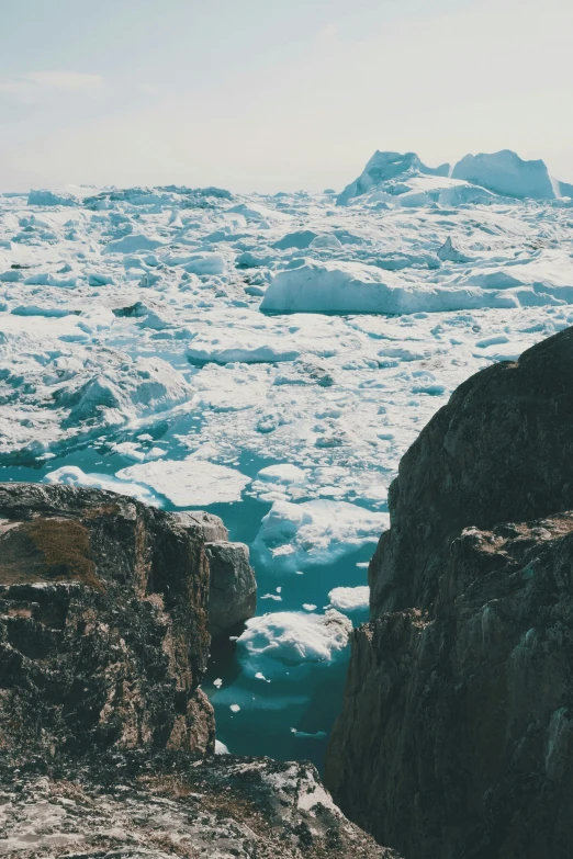 some ice in the ocean and one rock outcropping