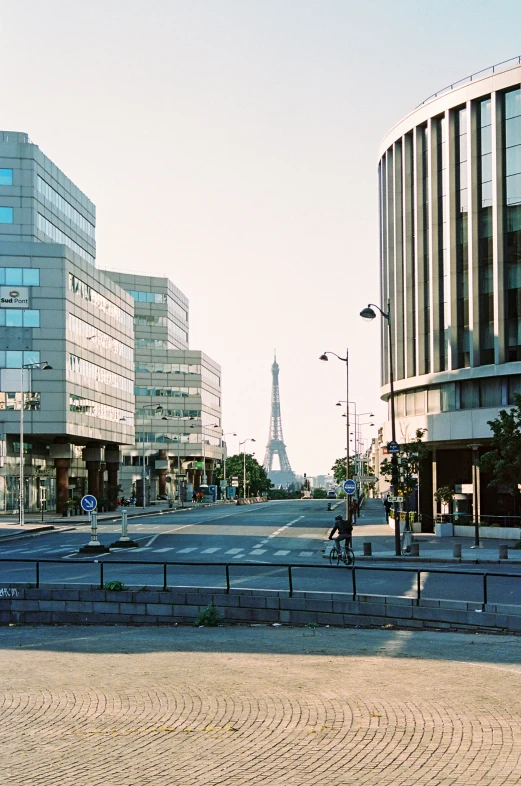 a brick walkway on a street with buildings in the background