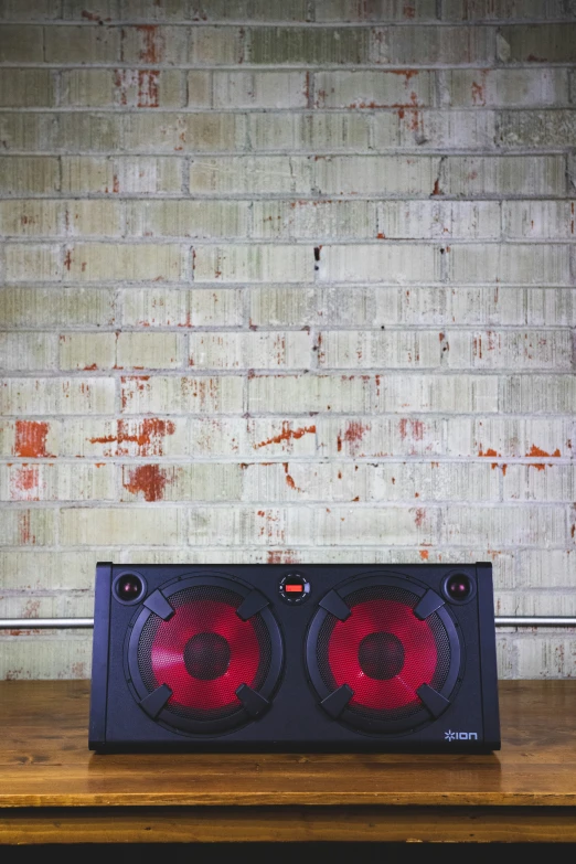 this image is of two speakers on a wooden table