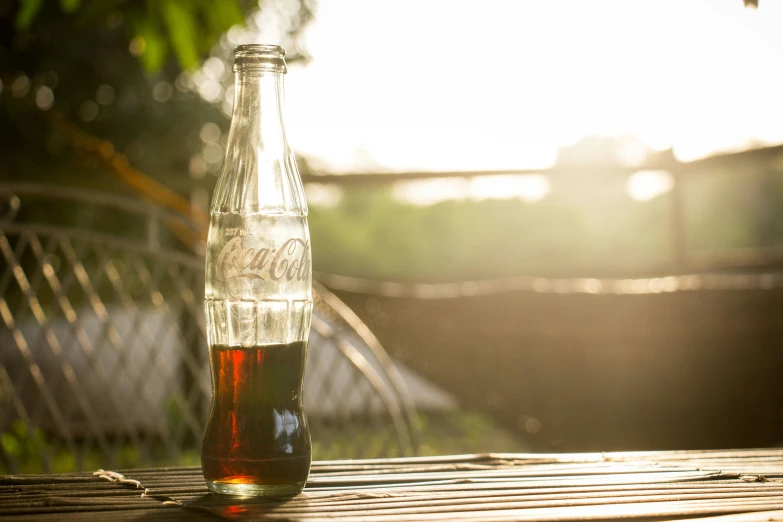 a brown bottle with red liquid sitting on a table