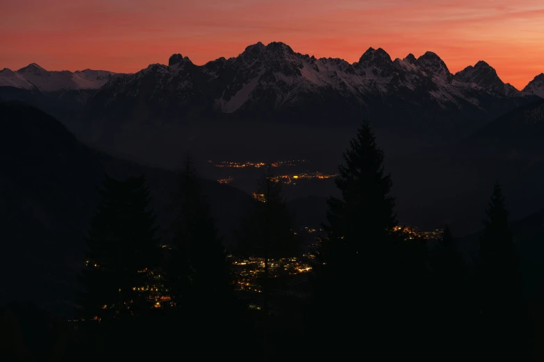 a view of some mountains in the distance at night