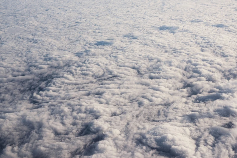 the view of white clouds and sky from an airplane