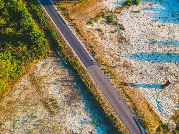 a small highway with a truck driving down it