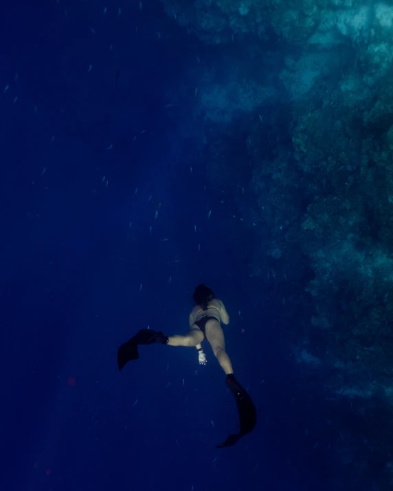 a woman with a snorkeld dives out into the water