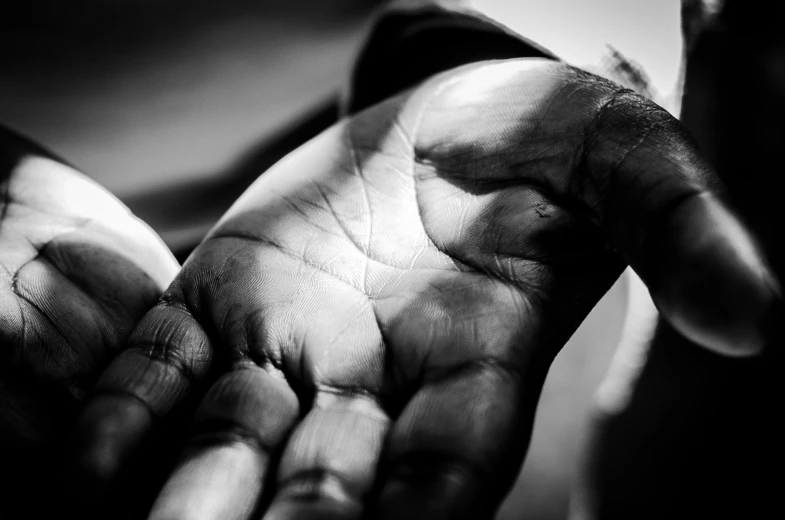 a person's hands holding soing in the dark