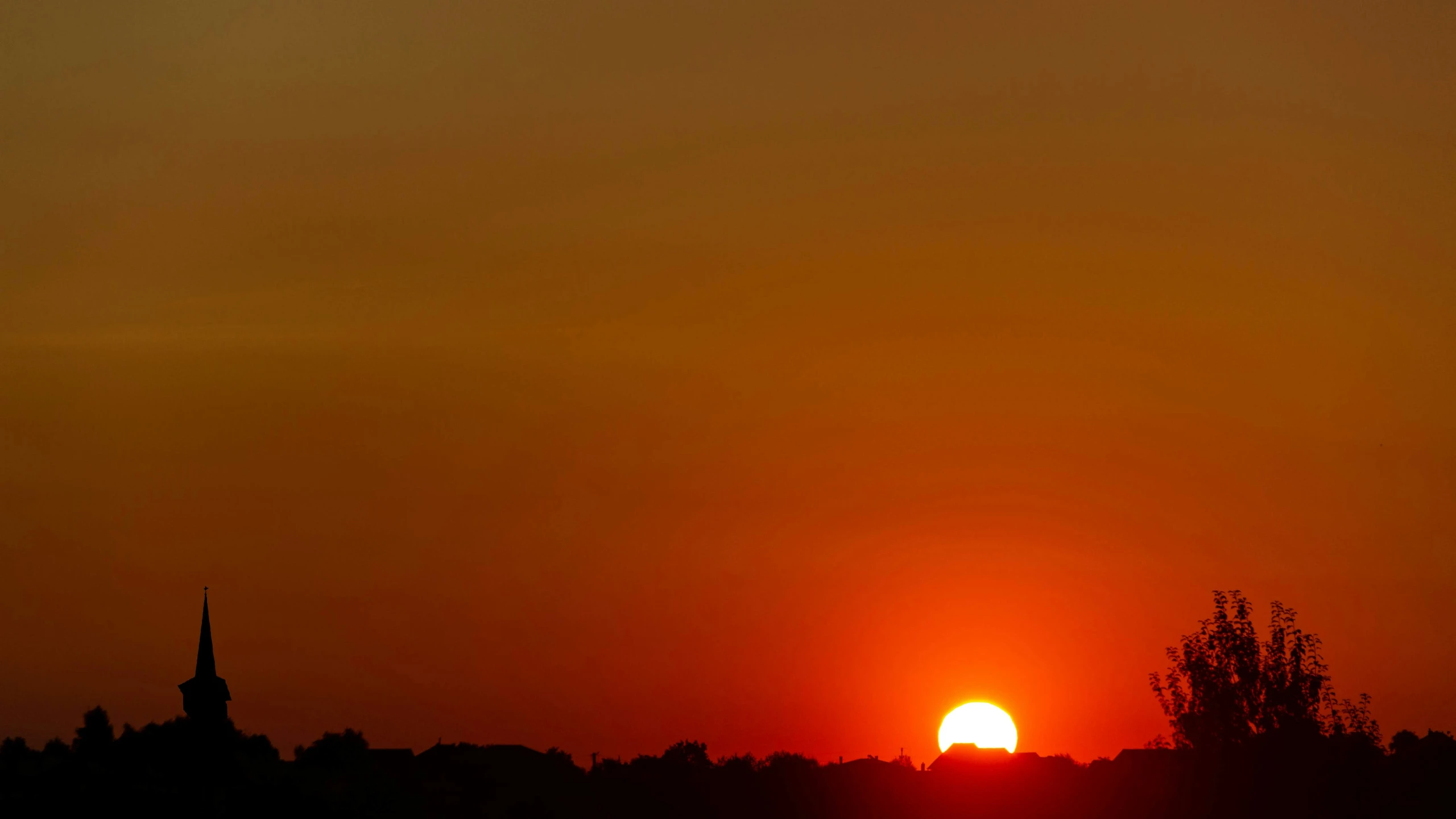 a picture of a sunset that is orange and red