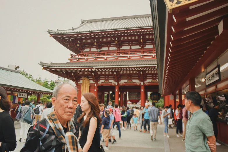 an old man and child standing in front of a building