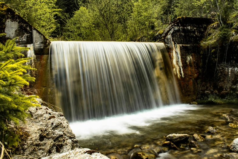 a big waterfall that is sitting in the middle of a forest