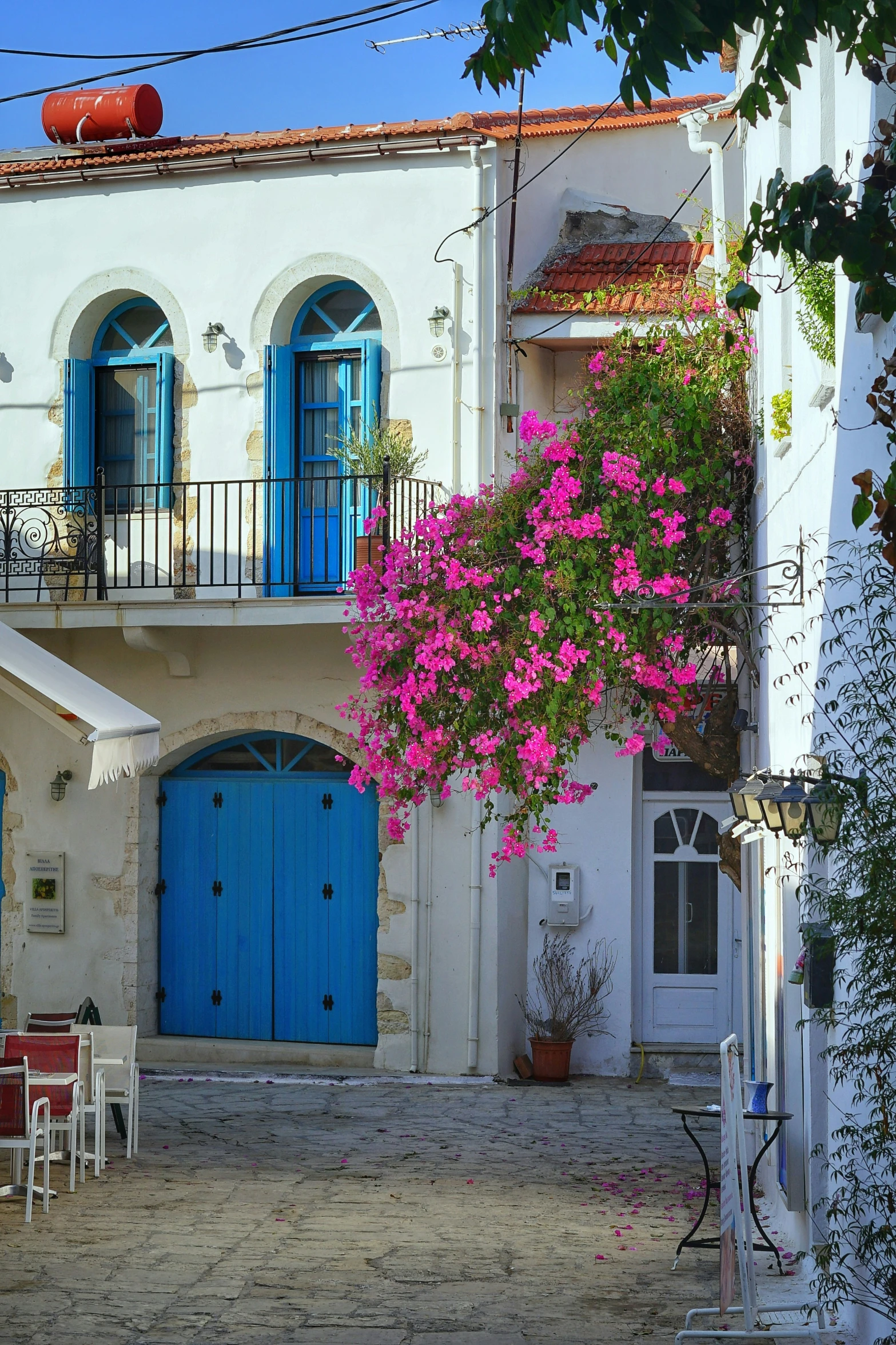 blue doors with bright windows and white building