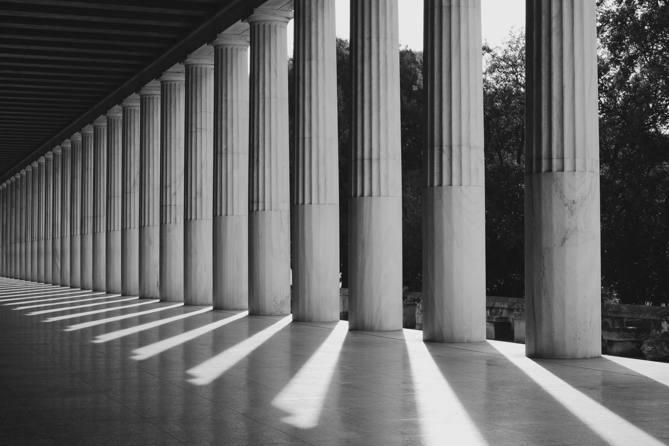 the columns at the top of the building are casting long shadows