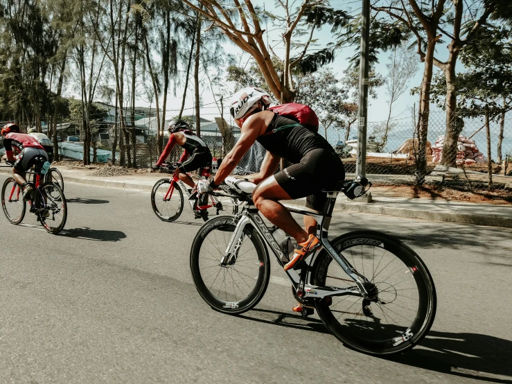 a group of people riding bikes down a street