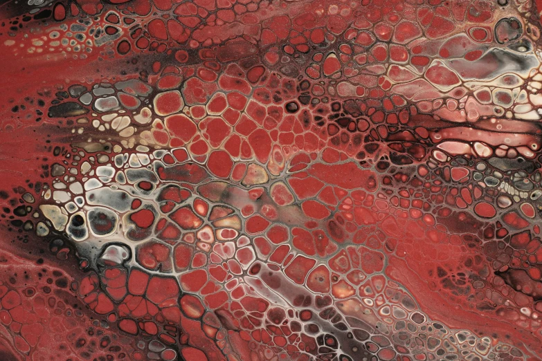 a large black, red and grey substance with lots of bubbles