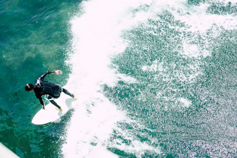 a person in a wet suit on a surfboard riding the waves