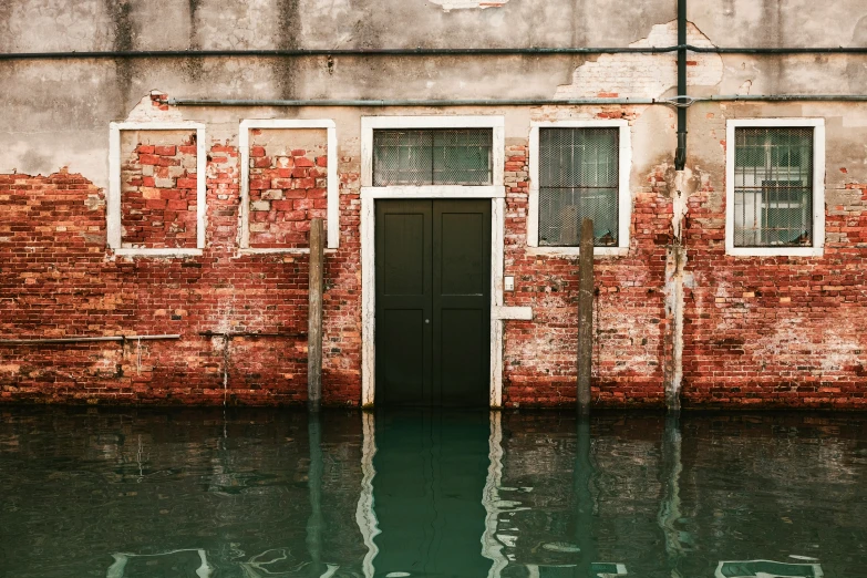 the front doors of a building that is flooded