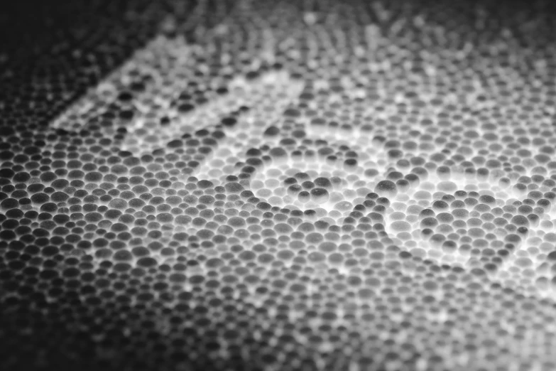 the word zoom in a pattern made up of circular white circles