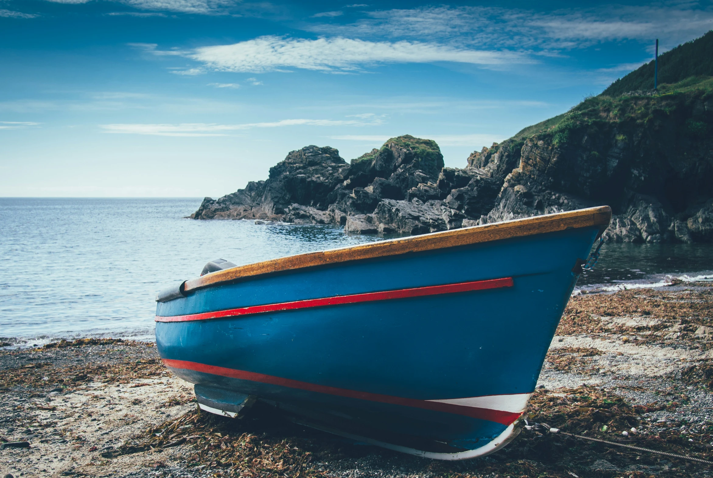 an old boat is docked on the beach