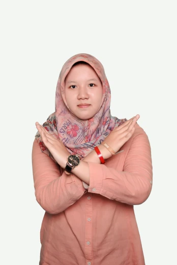 an muslim woman poses with her hands folded