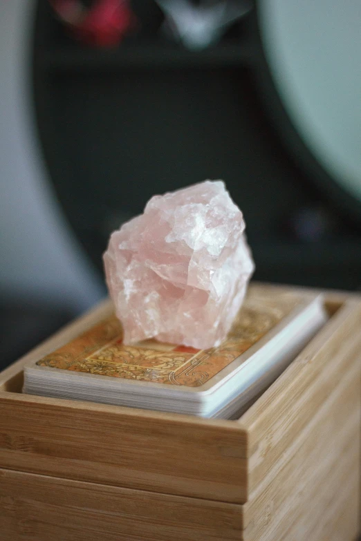 a rock sitting on top of a wooden box