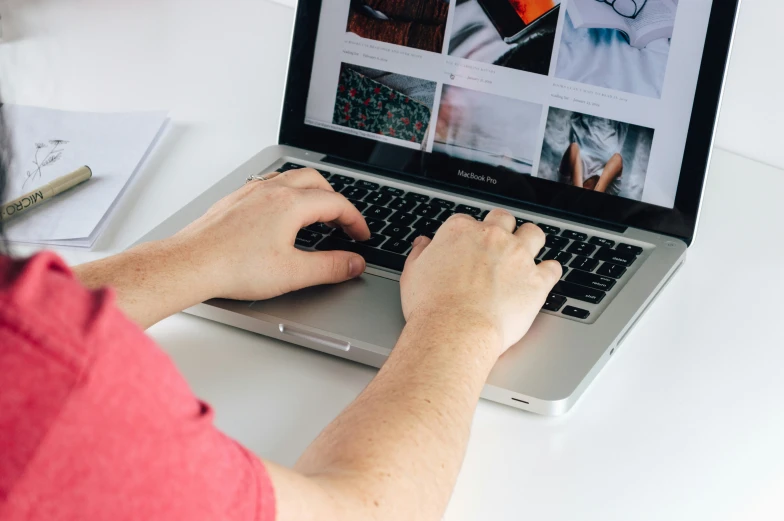 a person is using a laptop computer sitting at a desk