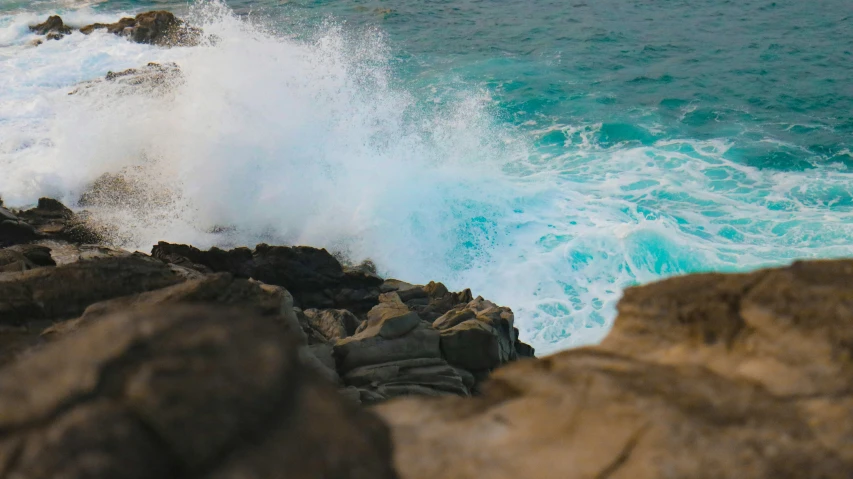 a very rough sea coast with a crashing wave