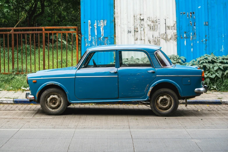 an old car parked next to a fence