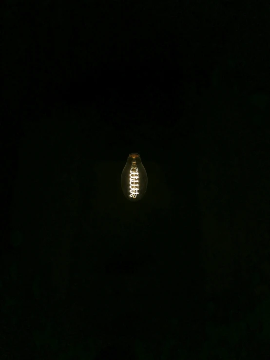 a street light sitting in the dark of night