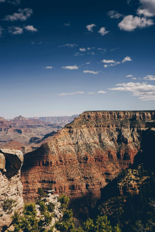 the view of a deep gorge from above with the mountains in the background