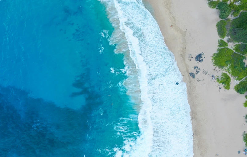 an aerial s of the beach and shoreline from the air
