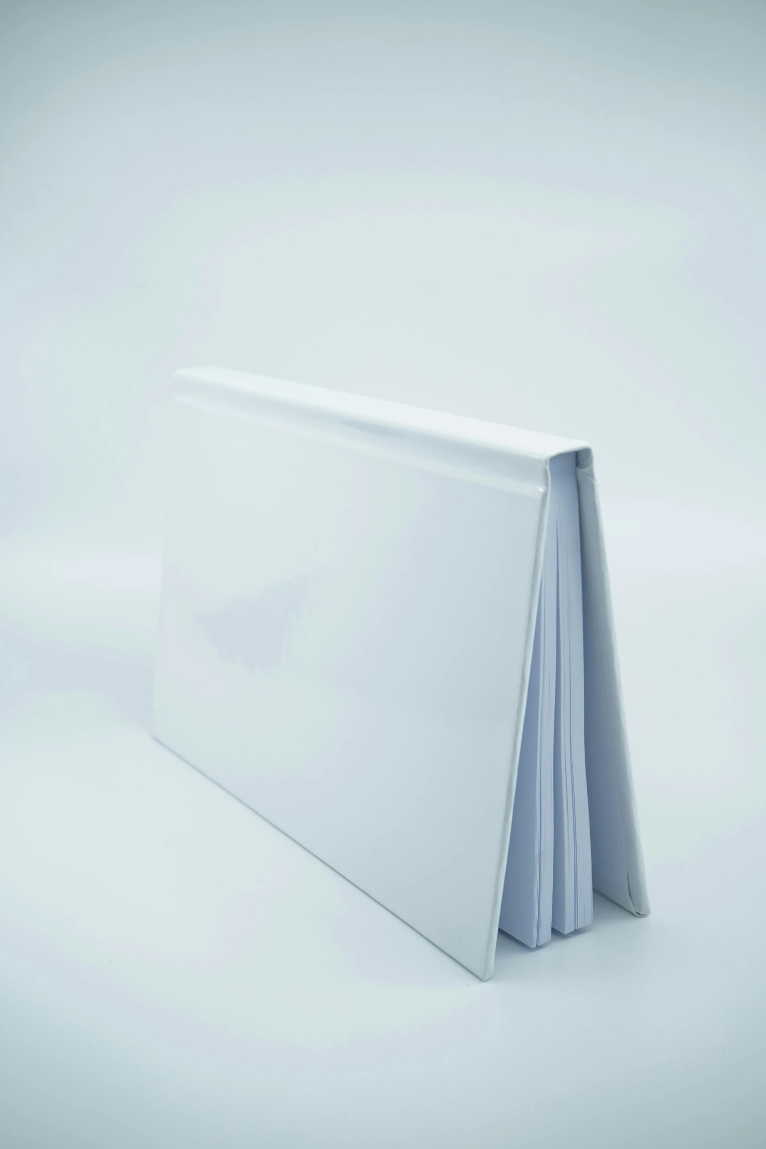 several blank papers are folded in a white folder