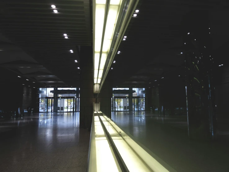 an empty building with many lights shines in the windows