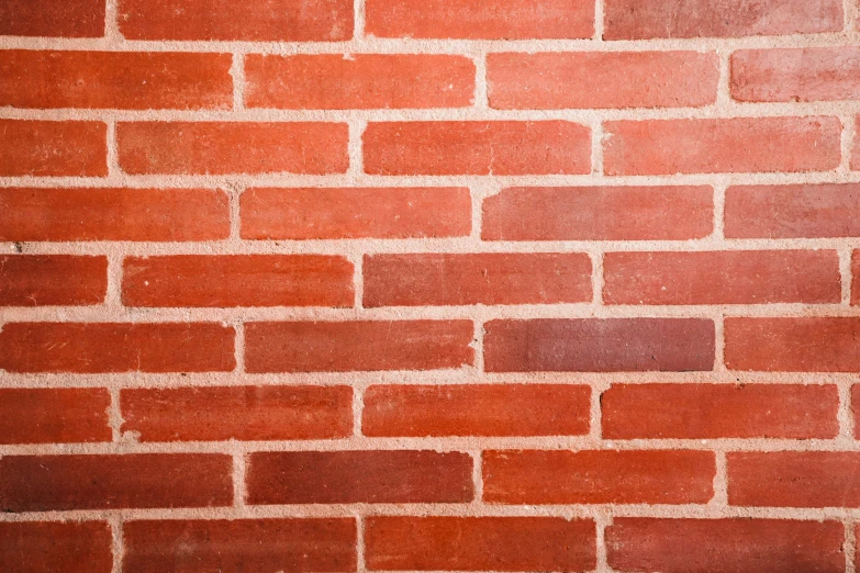 a close up of a brick wall with small bricks and cement