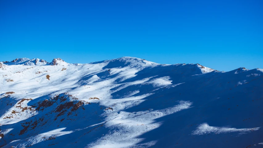 a man in the air on top of a snowboard