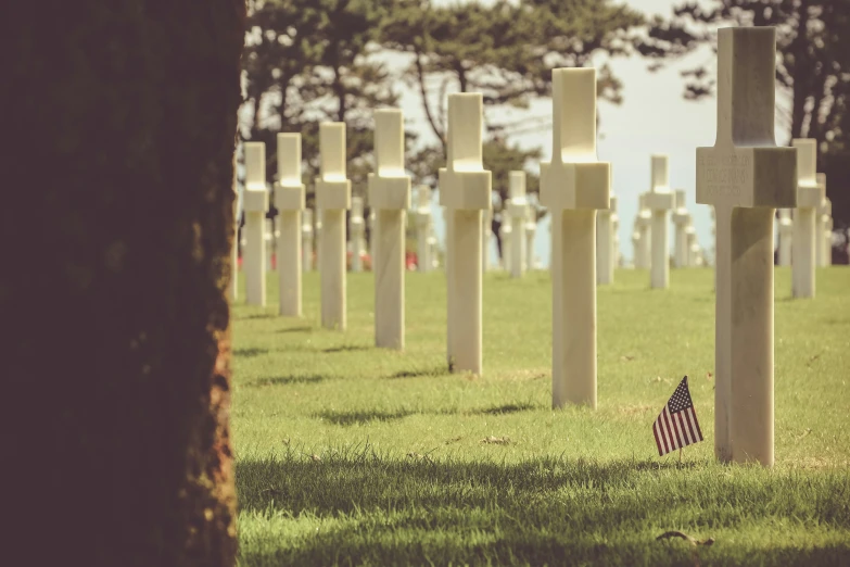 an american flag rests amongst a cemetery of headstones