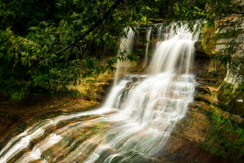 this is a waterfall in the woods next to the lake