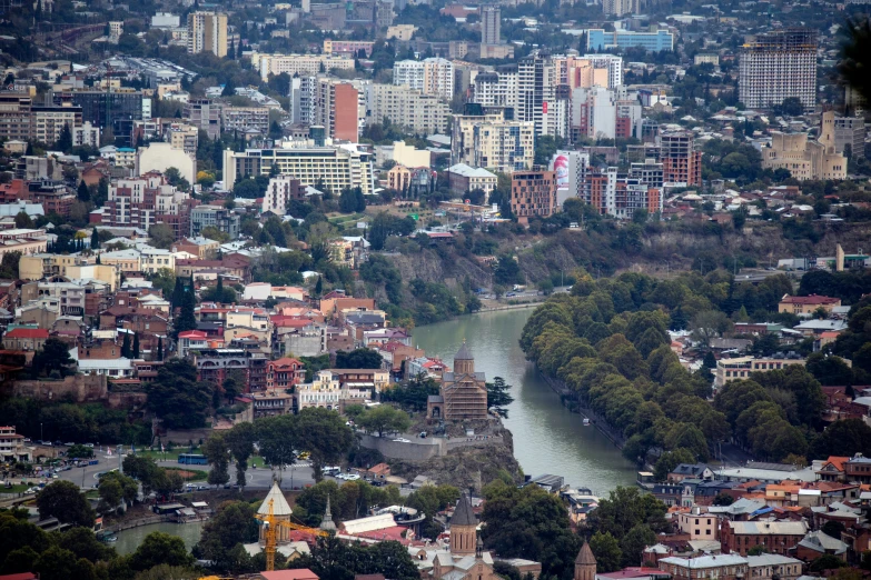 the view from above of some buildings, river and town