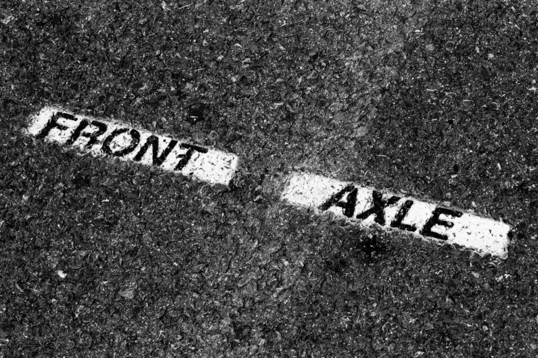 black and white pograph of a street sign on the sidewalk