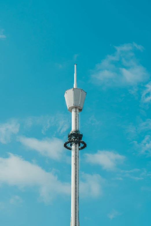 a light tower against a blue sky with a wreath on the side