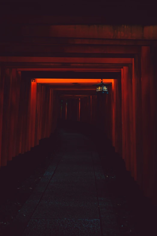 a po of a tunnel in the dark with some lights at the end