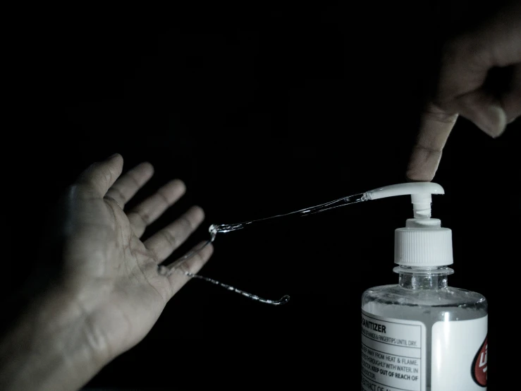 a hand holding a toothbrush and cleaning it