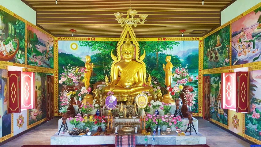 the buddha statue is surrounded by colorful paintings