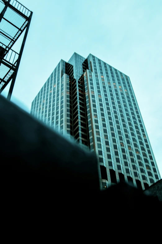 a tall building sitting next to a tall skyscr