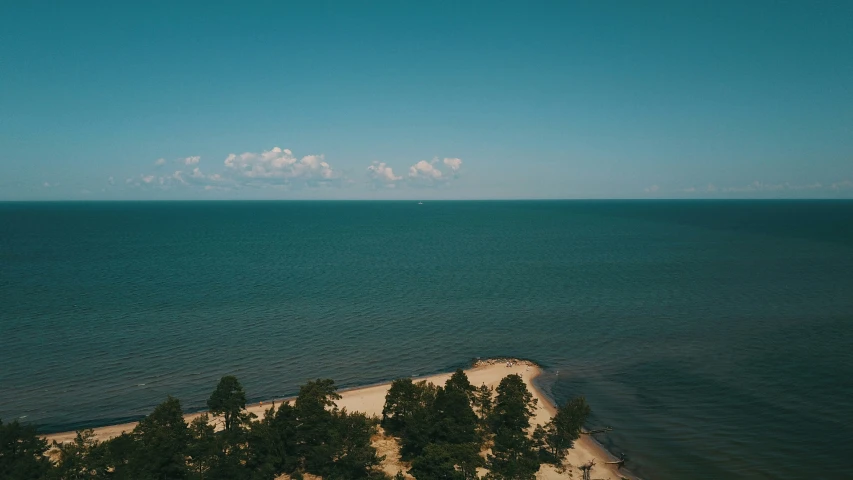 aerial view of blue water and white sandy beach